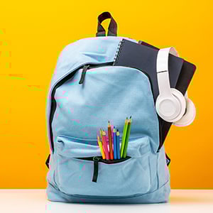 backpack with colored pencils, notebook, headphones