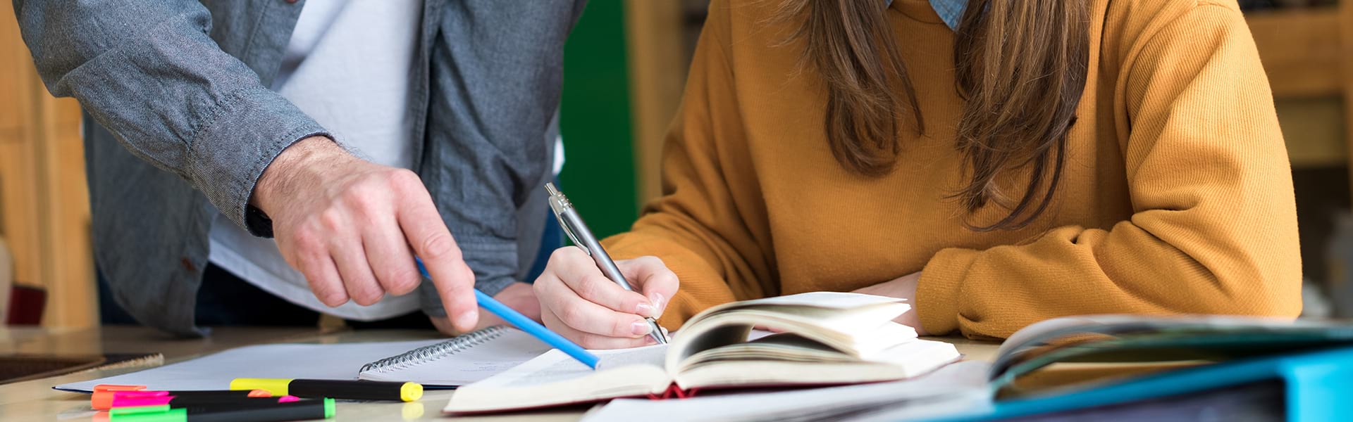 Teacher with a writing student