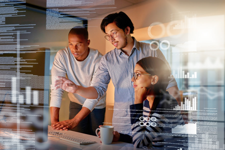 Two men and a women working in technology